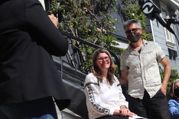 Photo of Michelle Foy and Fernando Martí at press conference in front of their house.