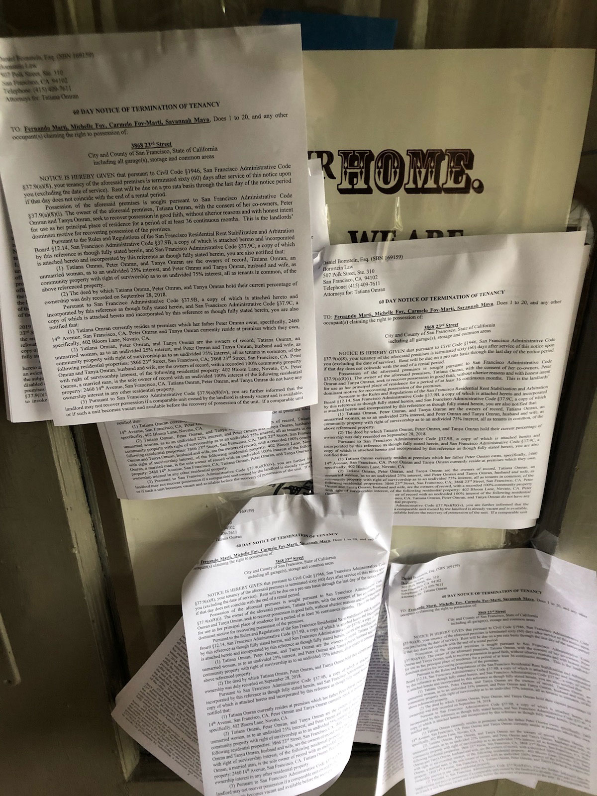 Photograph of eviction notices tapes to front door of Fernando Martí's apartment