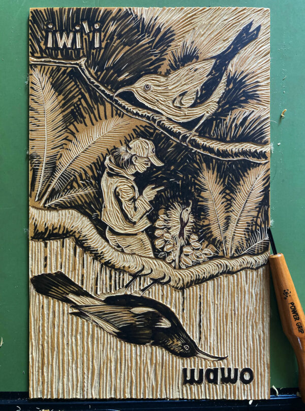 Photograph of linocut block in progress of being carved, with carving tool on one side.