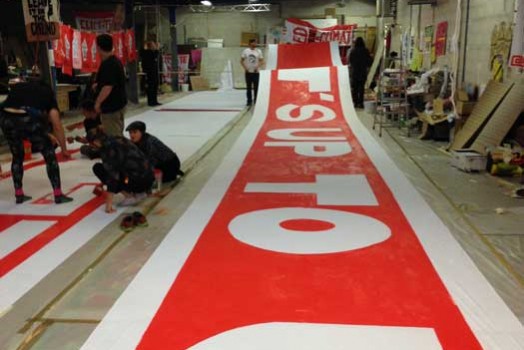 Painting 300 ft. banner for D12 demos in Paris